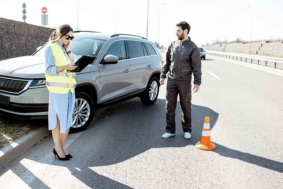 Woman and road worker during the car accident